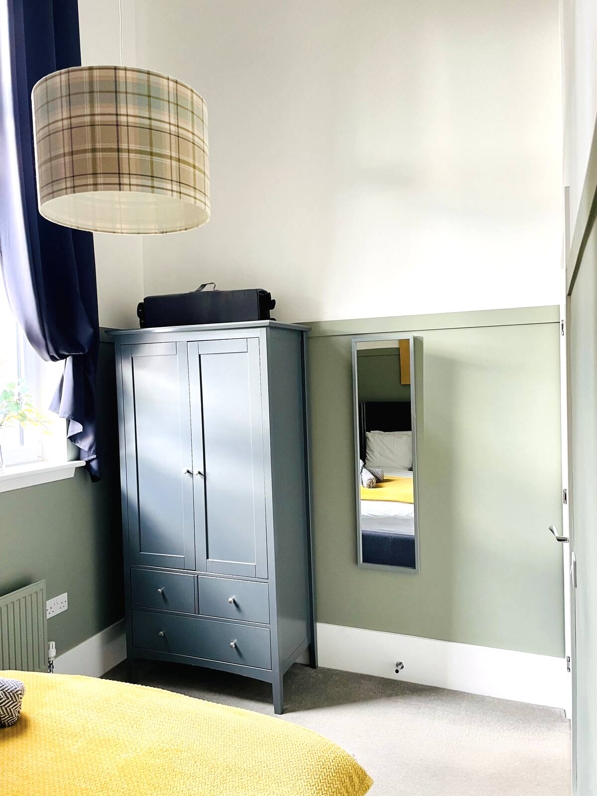 Double bedroom wardrobe, full-length mirror and tartan lampshade